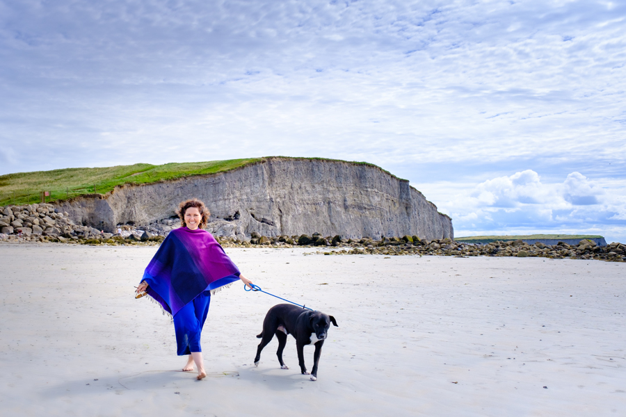 MaryPat and Al green in front of the Cliffs of Galway on White Strand beach in Barna